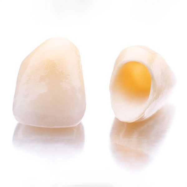 Two dental crowns on a white background