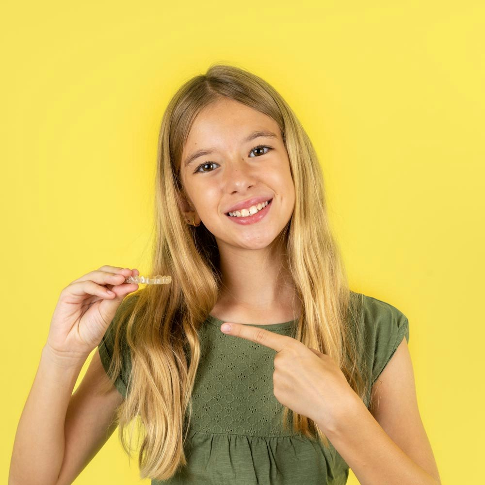 Invisalign aligner fitting over teeth